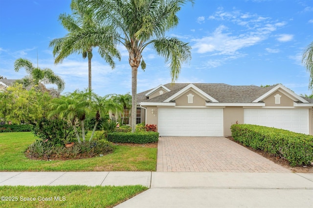 4341 Aberdeen Cir, Rockledge, FL 32955 - view of front facade with stucco siding, decorative driveway, an attached garage, and a front lawn