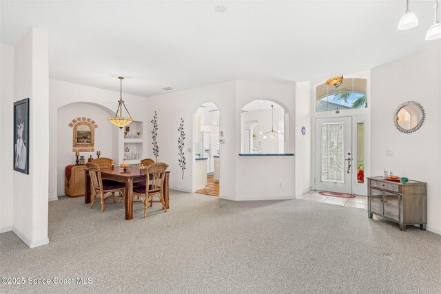 4341 Aberdeen Cir, Rockledge, FL 32955 - dining space with light colored carpet, arched walkways, and baseboards