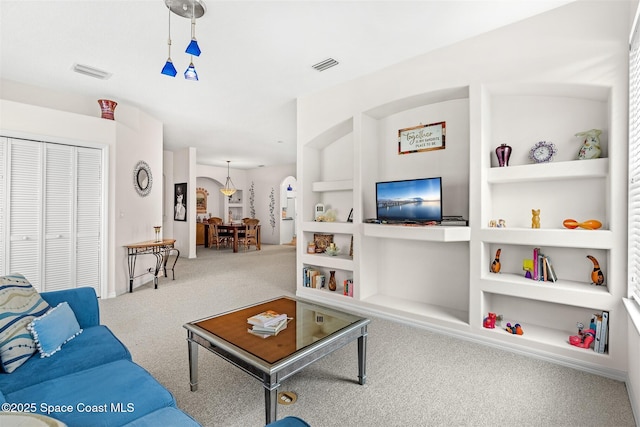 4341 Aberdeen Cir, Rockledge, FL 32955 - carpeted living area with built in shelves and arched walkways