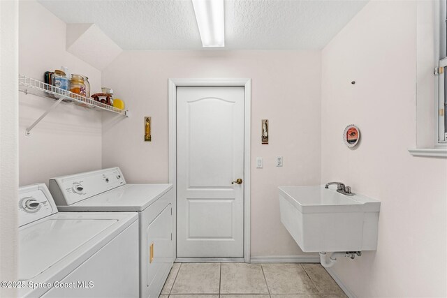 4341 Aberdeen Cir, Rockledge, FL 32955 - washroom featuring washer and dryer, light tile patterned floors, a textured ceiling, and baseboards
