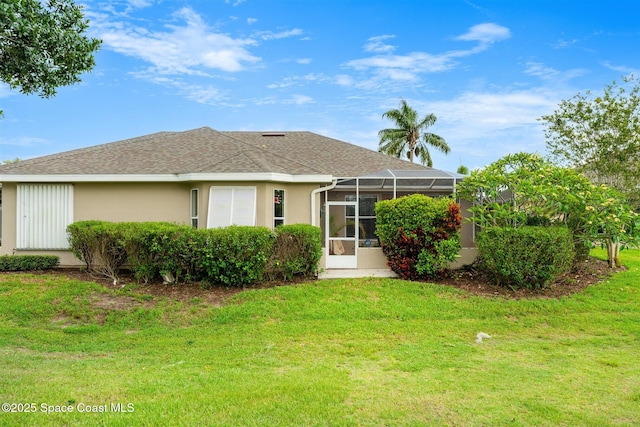 4341 Aberdeen Cir, Rockledge, FL 32955 - back of property with a lawn, stucco siding, roof with shingles, and a lanai