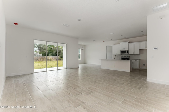 1795 Fallon Blvd NE Unit 06, Palm Bay, FL 32907 - unfurnished living room featuring a sink and baseboards