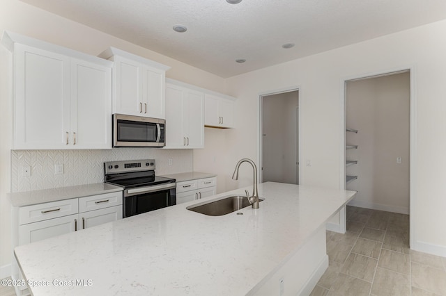 1795 Fallon Blvd NE Unit 06, Palm Bay, FL 32907 - kitchen featuring stainless steel appliances, a sink, and white cabinets
