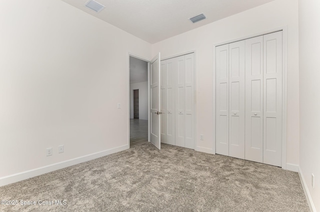 1795 Fallon Blvd NE Unit 06, Palm Bay, FL 32907 - unfurnished bedroom featuring carpet floors, two closets, and baseboards