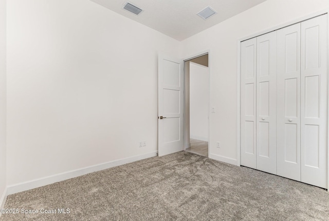 1795 Fallon Blvd NE Unit 06, Palm Bay, FL 32907 - unfurnished bedroom featuring carpet, baseboards, and a closet