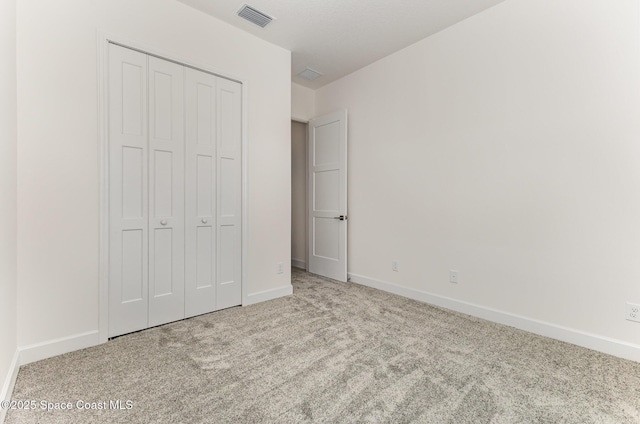 1795 Fallon Blvd NE Unit 06, Palm Bay, FL 32907 - unfurnished bedroom featuring carpet, baseboards, and a closet