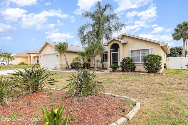 409 Americana Blvd NE, Palm Bay, FL 32907 - view of front facade featuring stucco siding, an attached garage, and concrete driveway