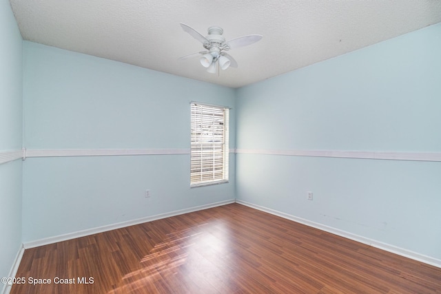 409 Americana Blvd NE, Palm Bay, FL 32907 - unfurnished room with ceiling fan, wood finished floors, and baseboards