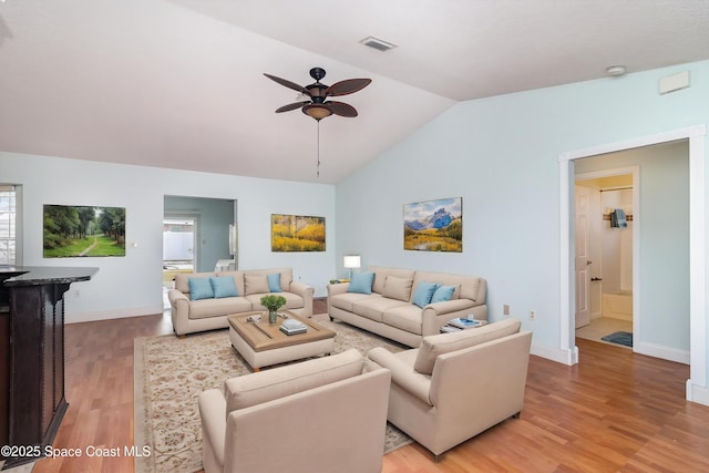 409 Americana Blvd NE, Palm Bay, FL 32907 - living area featuring vaulted ceiling, a ceiling fan, light wood-type flooring, and baseboards