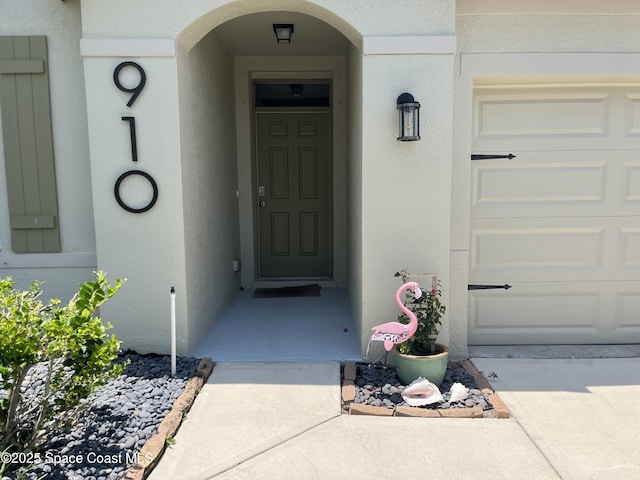 910 Swiss Pointe Ln, Rockledge, FL 32955 - entrance to property featuring stucco siding and a garage