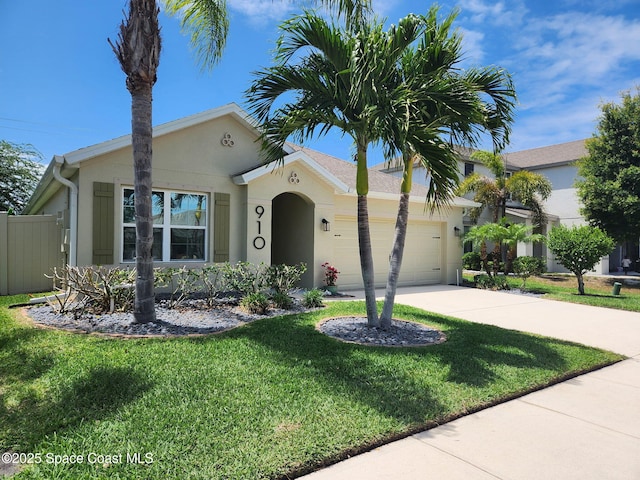 910 Swiss Pointe Ln, Rockledge, FL 32955 - view of front facade with a garage, stucco siding, and driveway