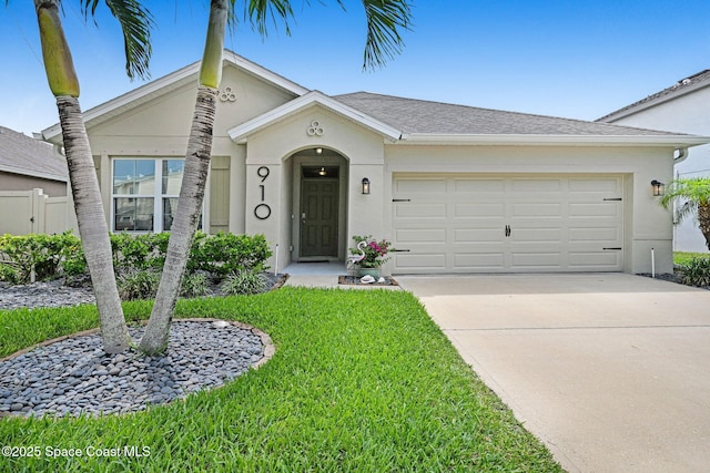 910 Swiss Pointe Ln, Rockledge, FL 32955 - view of front of home featuring driveway, an attached garage, stucco siding, and a front yard