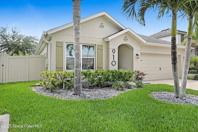 910 Swiss Pointe Ln, Rockledge, FL 32955 - view of front of home with a garage, stucco siding, and driveway