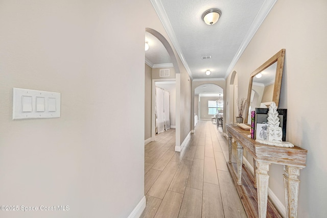 910 Swiss Pointe Ln, Rockledge, FL 32955 - hallway with arched walkways, light wood finished floors, crown molding, and a textured ceiling