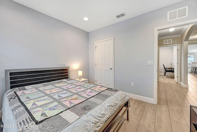 910 Swiss Pointe Ln, Rockledge, FL 32955 - bedroom with arched walkways, light wood-style flooring, and recessed lighting