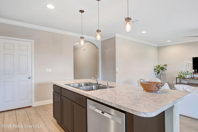 910 Swiss Pointe Ln, Rockledge, FL 32955 - kitchen with stainless steel dishwasher, wood finish floors, light countertops, pendant lighting, and arched walkways