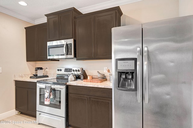 910 Swiss Pointe Ln, Rockledge, FL 32955 - kitchen featuring appliances with stainless steel finishes, dark brown cabinets, crown molding, and recessed lighting