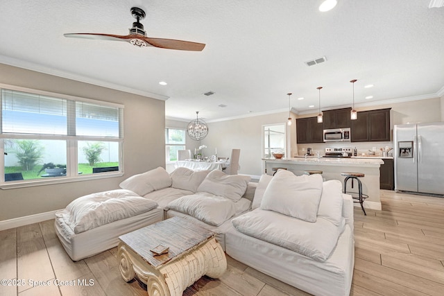 910 Swiss Pointe Ln, Rockledge, FL 32955 - living area with ceiling fan, light wood-style floors, recessed lighting, crown molding, and a chandelier