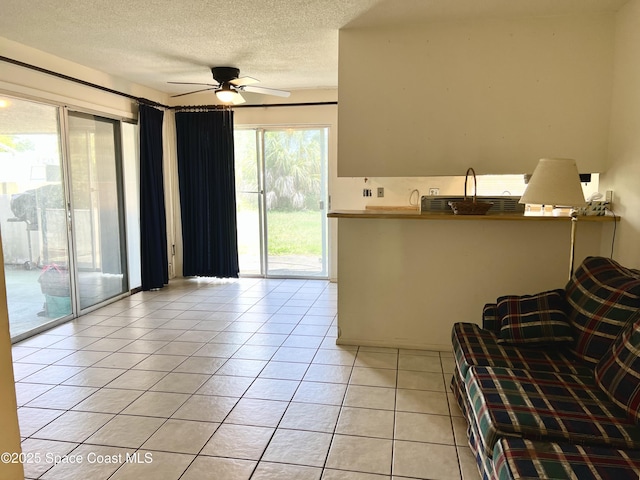 1899 Barker St NE, Palm Bay, FL 32907 - living area with light tile patterned flooring, a ceiling fan, and a textured ceiling