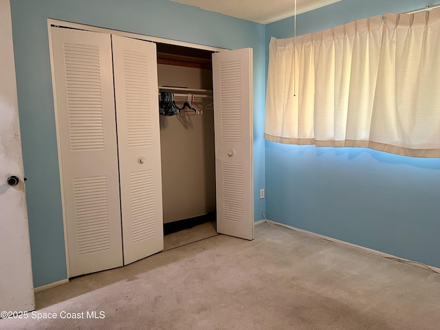 1899 Barker St NE, Palm Bay, FL 32907 - unfurnished bedroom featuring carpet floors, a closet, and baseboards