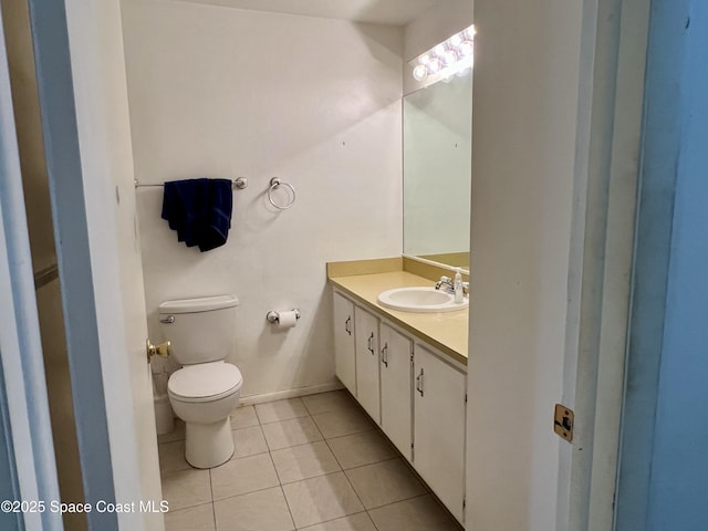 1899 Barker St NE, Palm Bay, FL 32907 - half bathroom featuring toilet, tile patterned flooring, vanity, and baseboards
