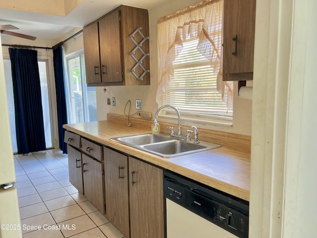 1899 Barker St NE, Palm Bay, FL 32907 - kitchen with white dishwasher, a sink, light countertops, and light tile patterned floors