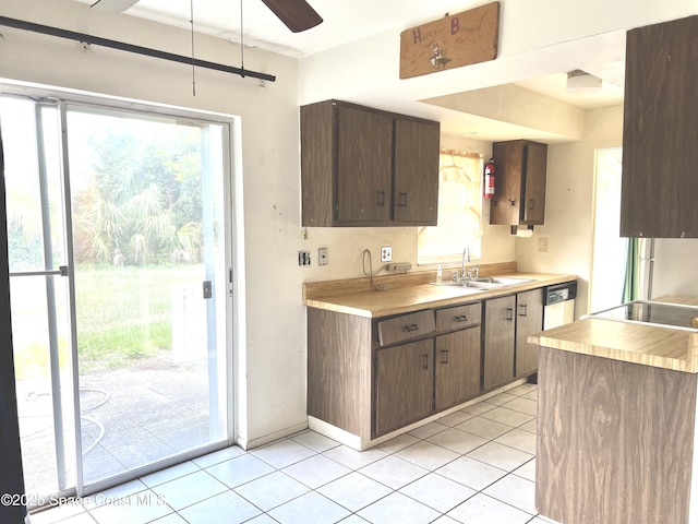 1899 Barker St NE, Palm Bay, FL 32907 - kitchen featuring a sink, light countertops, light tile patterned flooring, and plenty of natural light