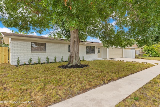 1340 Lester Ct, Merritt Island, FL 32952 - single story home with an attached garage, driveway, and brick siding