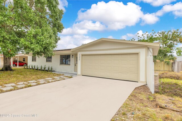 1340 Lester Ct, Merritt Island, FL 32952 - single story home with driveway, roof mounted solar panels, an attached garage, and brick siding