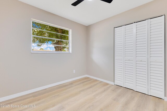 1340 Lester Ct, Merritt Island, FL 32952 - unfurnished bedroom featuring wood finished floors, baseboards, a closet, and ceiling fan