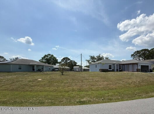 982 Colonial Ave SE, Palm Bay, FL 32909 - view of yard with a garage