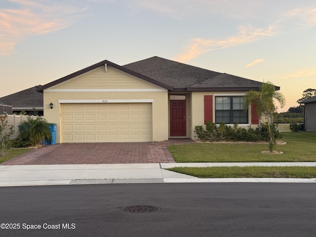 7055 Topaz Dr, Grant-Valkaria, FL 32949 - ranch-style house featuring decorative driveway, a front lawn, a garage, and stucco siding