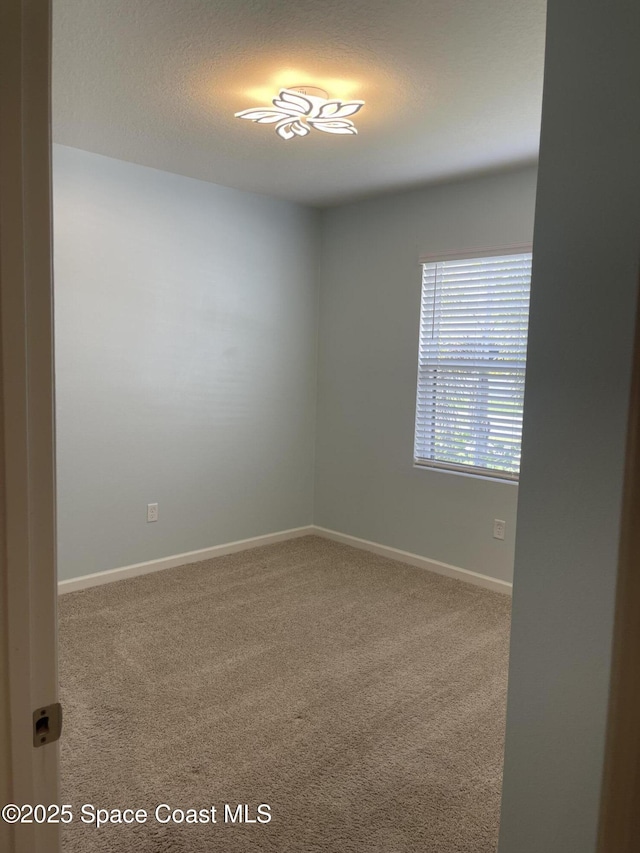 7055 Topaz Dr, Grant-Valkaria, FL 32949 - carpeted spare room featuring baseboards and a textured ceiling