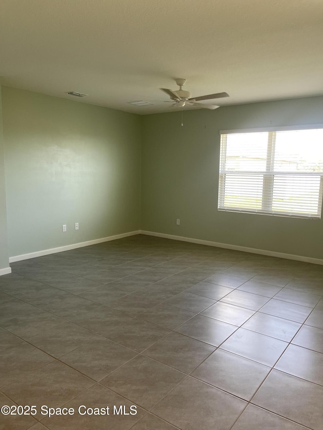 7055 Topaz Dr, Grant-Valkaria, FL 32949 - tiled spare room with a ceiling fan and baseboards