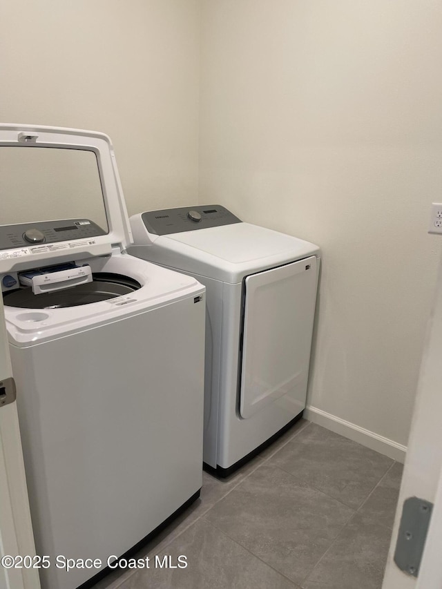 7055 Topaz Dr, Grant-Valkaria, FL 32949 - washroom with washer and clothes dryer and tile patterned flooring