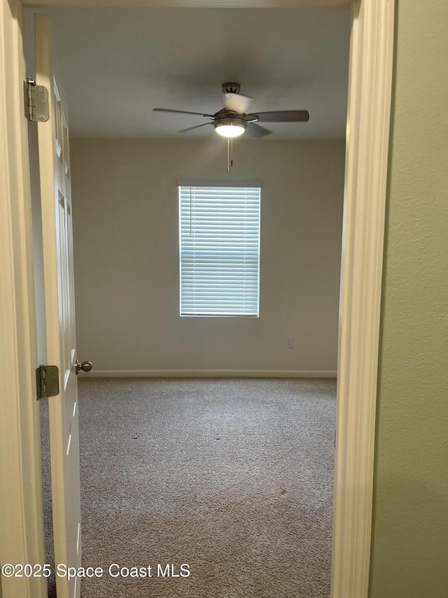 7055 Topaz Dr, Grant-Valkaria, FL 32949 - unfurnished room with carpet floors and a ceiling fan