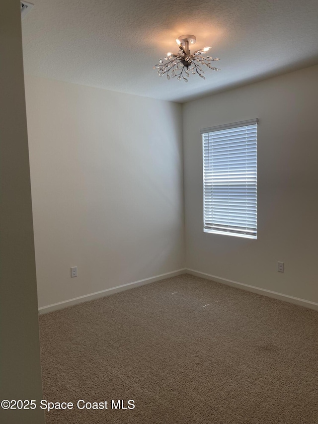 7055 Topaz Dr, Grant-Valkaria, FL 32949 - carpeted spare room with a chandelier and baseboards