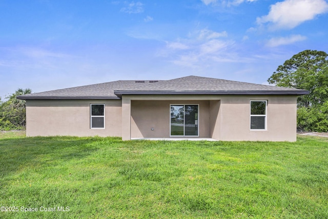1422 Van Dyke Ave SE, Palm Bay, FL 32909 - back of property featuring a yard, stucco siding, and a shingled roof