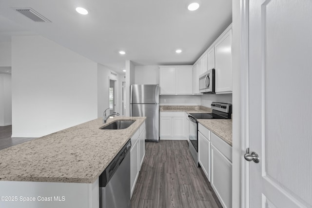 1422 Van Dyke Ave SE, Palm Bay, FL 32909 - kitchen featuring appliances with stainless steel finishes, a sink, dark wood-style floors, white cabinetry, and recessed lighting