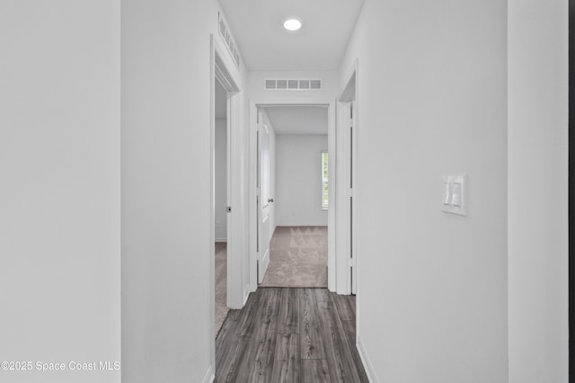1422 Van Dyke Ave SE, Palm Bay, FL 32909 - hallway featuring baseboards, dark wood-style flooring, and dark carpet