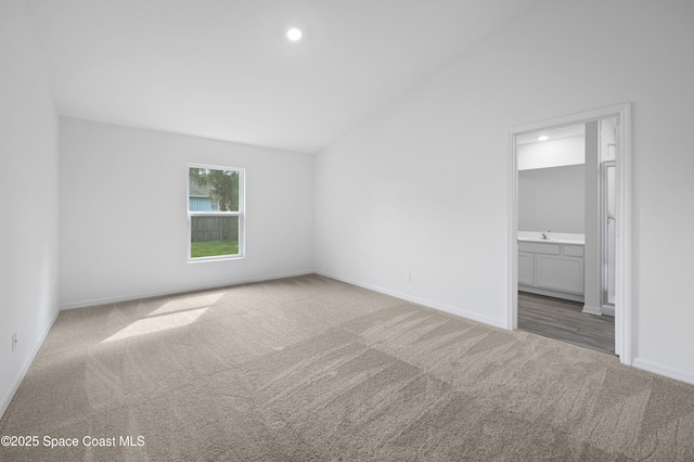 1422 Van Dyke Ave SE, Palm Bay, FL 32909 - unfurnished bedroom with carpet, baseboards, recessed lighting, ensuite bathroom, and vaulted ceiling