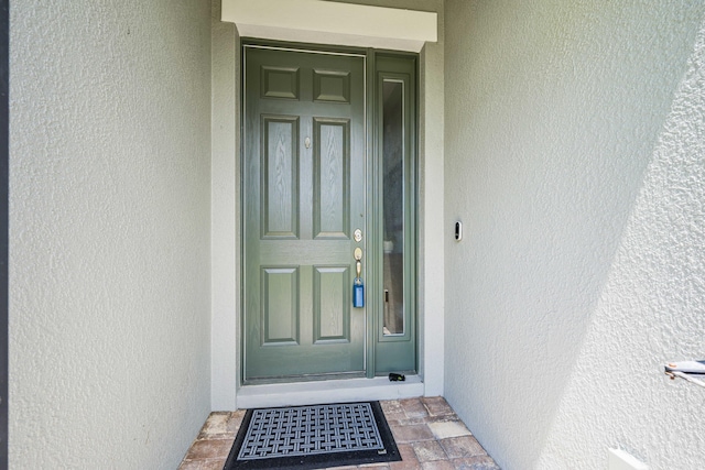 2611 Ballydoyle Ln, Melbourne, FL 32940 - doorway to property with stucco siding