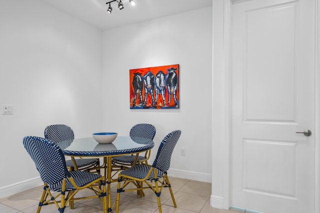2611 Ballydoyle Ln, Melbourne, FL 32940 - dining room featuring baseboards, light tile patterned floors, and rail lighting