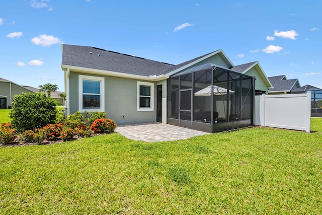 2611 Ballydoyle Ln, Melbourne, FL 32940 - back of house featuring stucco siding, roof with shingles, a patio, and a sunroom
