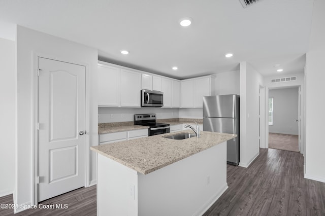 1170 Pluto St SE, Palm Bay, FL 32909 - kitchen with appliances with stainless steel finishes, a sink, white cabinets, baseboards, and dark wood finished floors