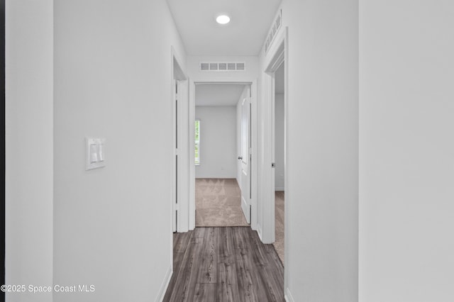 1170 Pluto St SE, Palm Bay, FL 32909 - corridor featuring baseboards, dark wood-type flooring, and dark colored carpet