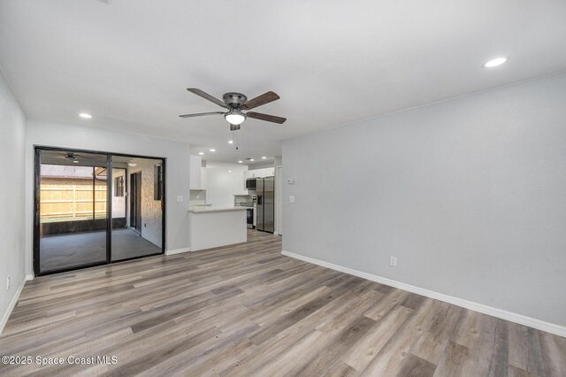 1521 Baker St NE, Palm Bay, FL 32907 - unfurnished living room with a ceiling fan, light wood finished floors, recessed lighting, and baseboards