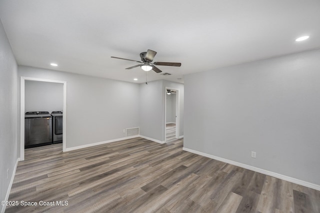1521 Baker St NE, Palm Bay, FL 32907 - unfurnished room with separate washer and dryer, a ceiling fan, wood finished floors, recessed lighting, and baseboards