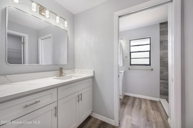 1521 Baker St NE, Palm Bay, FL 32907 - bathroom with wood finished floors, vanity, and baseboards