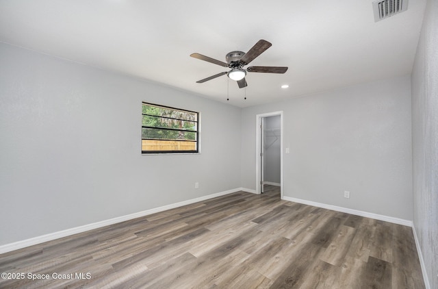 1521 Baker St NE, Palm Bay, FL 32907 - unfurnished room featuring ceiling fan, wood finished floors, baseboards, and recessed lighting